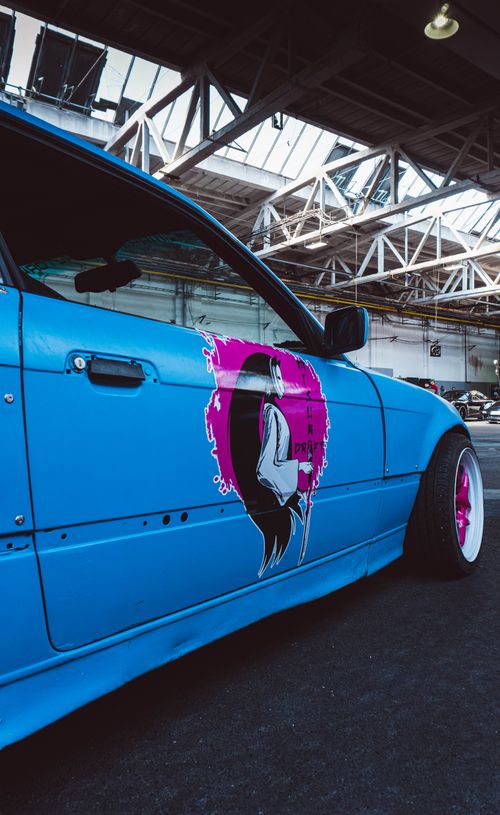 Free Vibrant custom BMW E36 sports car in an urban Slovak environment, showcasing unique art and tuning. Stock Photo
