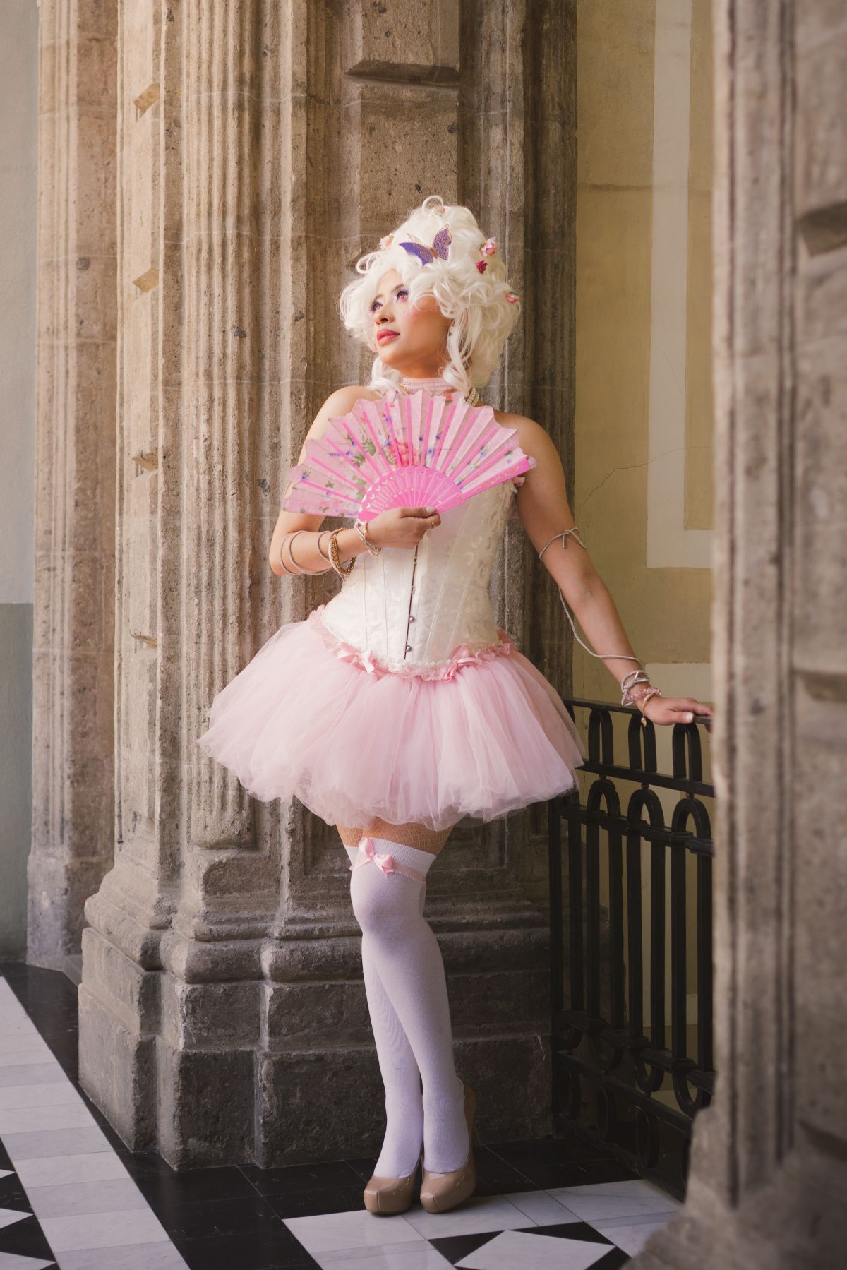 A Woman Wearing a Costume and a Wig Sitting on a Chair · Free Stock Photo