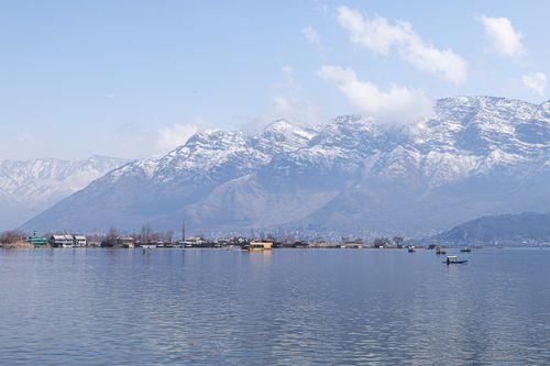 Free Beautiful view of Dal Lake in Srinagar, with snow-capped mountains in the background and serene waters. Stock Photo