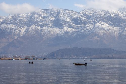 Free Breathtaking view of Dal Lake with snowy Himalayas in the background in Srinagar. Stock Photo