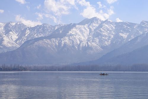 Free Beautiful view of Dal Lake in Srinagar with snowcapped mountains and a traditional boat. Stock Photo