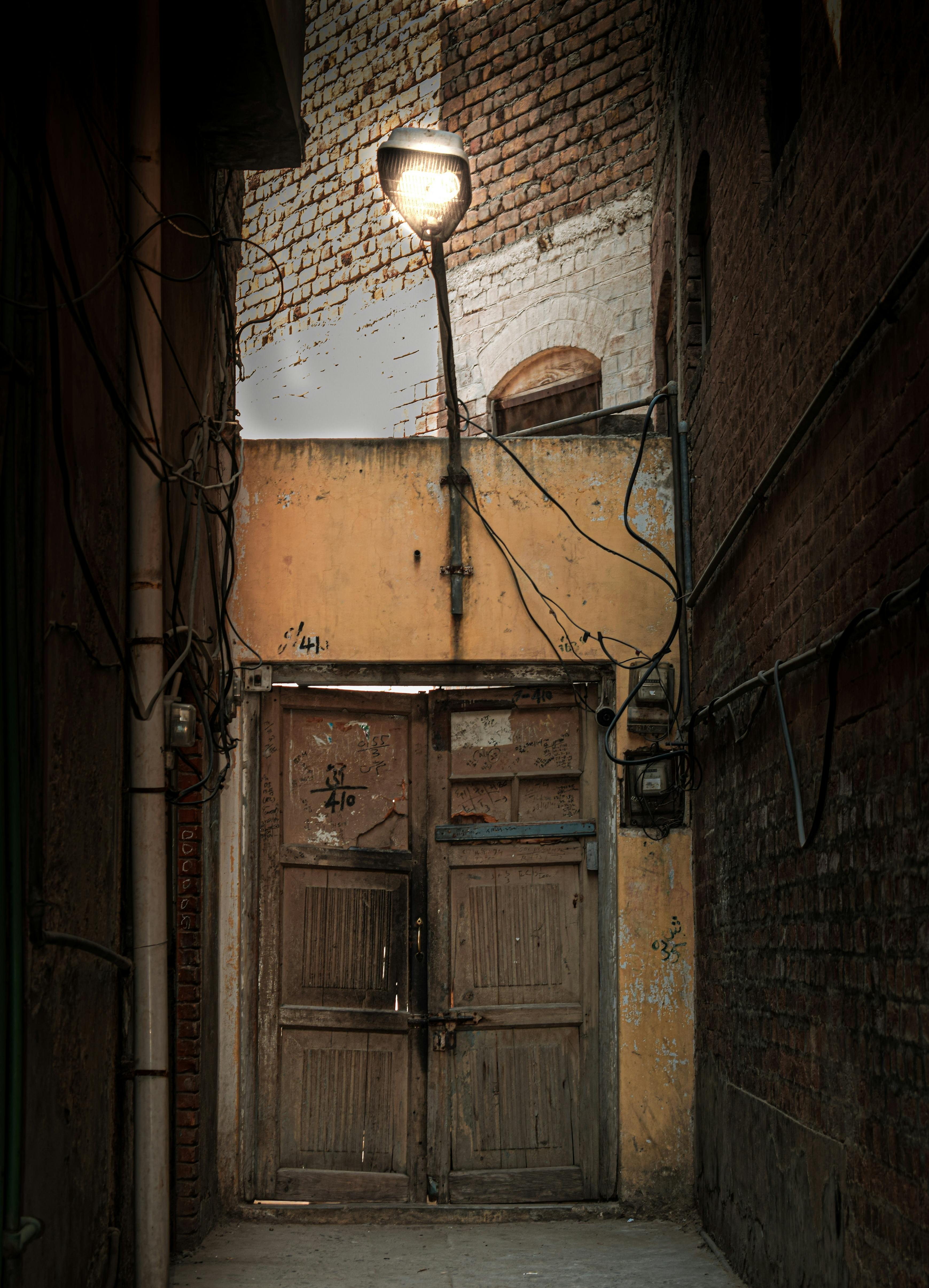 wooden door below a street light