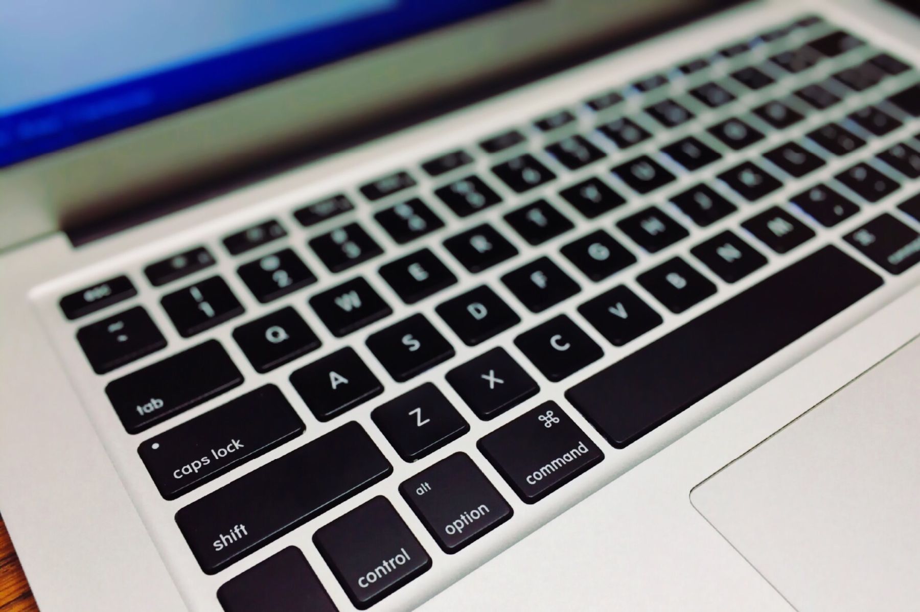 Laptop keyboard and coding workspace