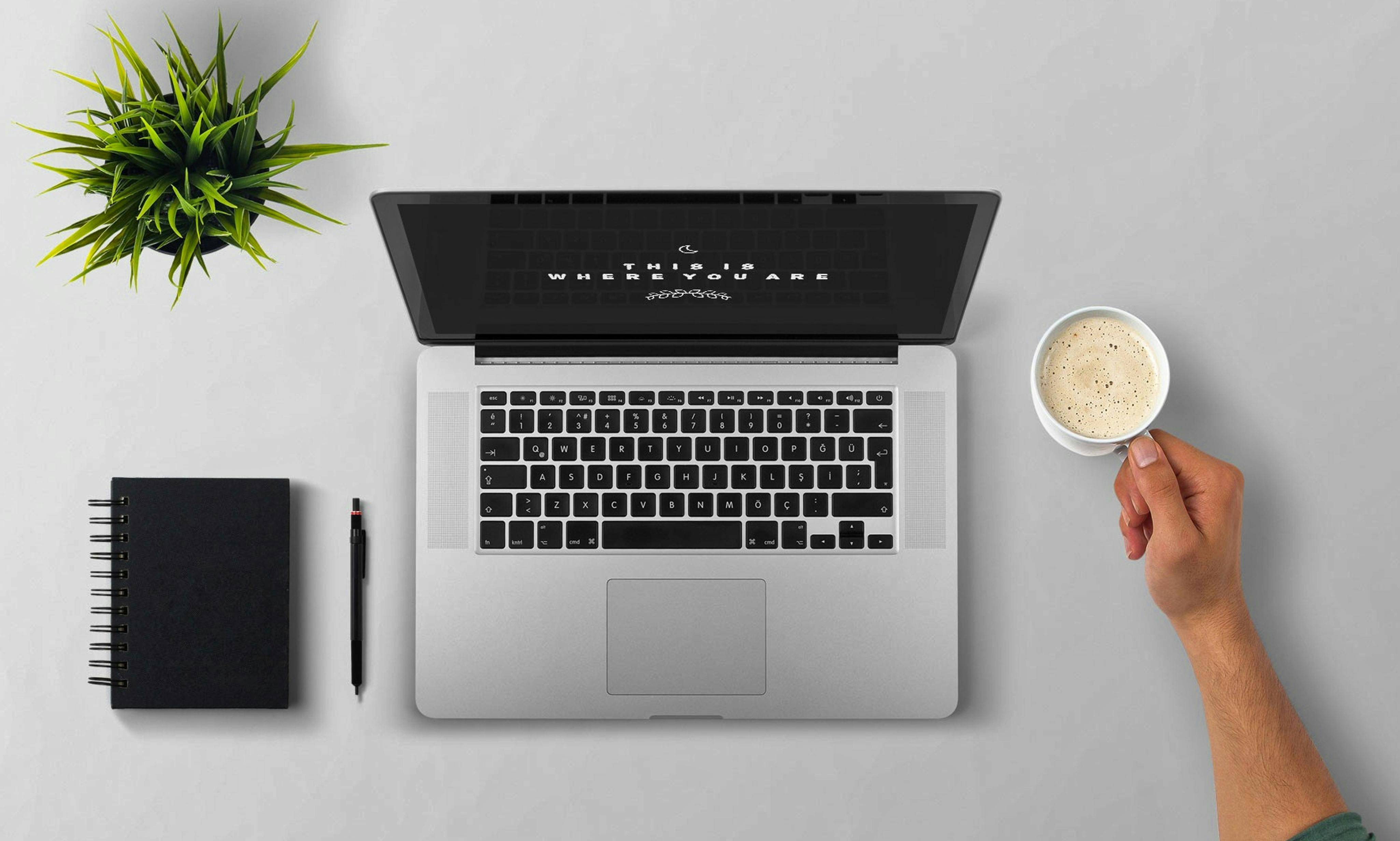 Man Using Laptop on Table Against White Background · Free Stock Photo