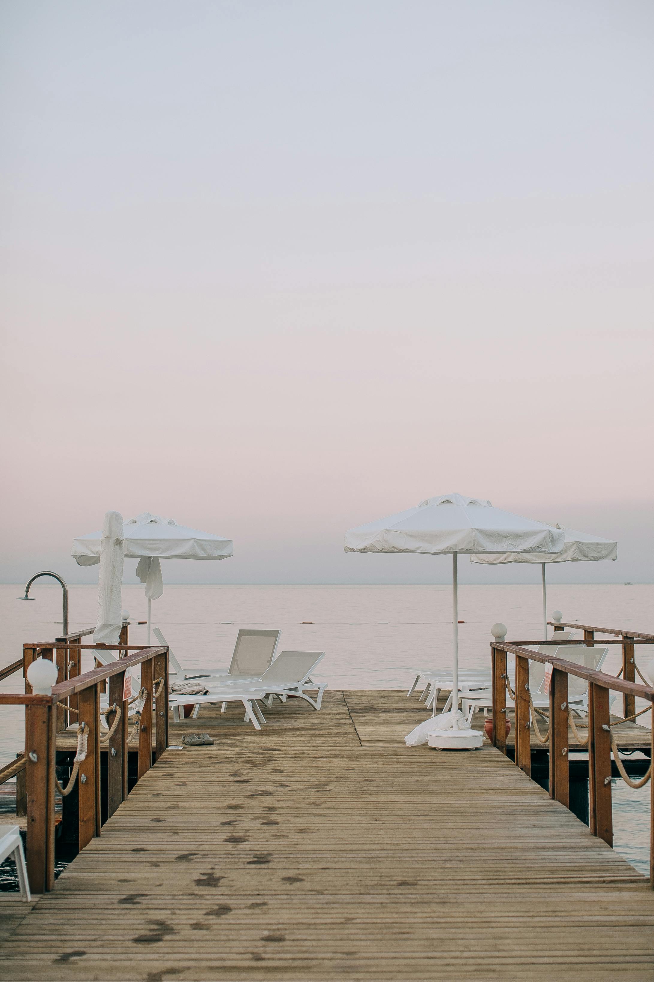sun loungers and beach umbrellas standing on a pier