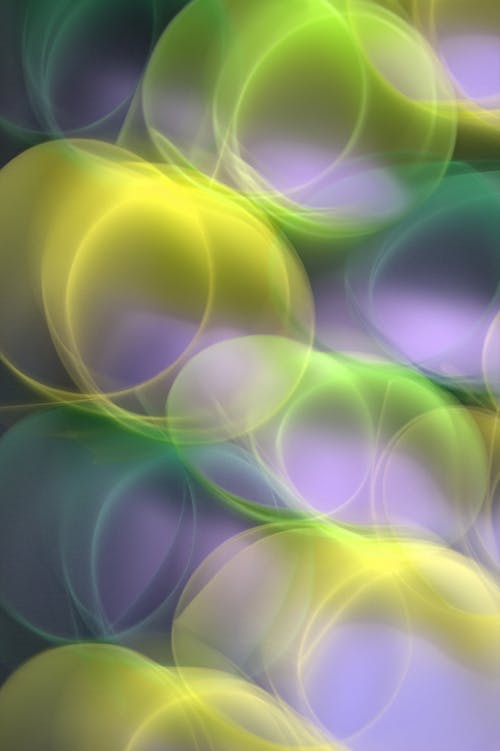 A purple and green abstract background with circles