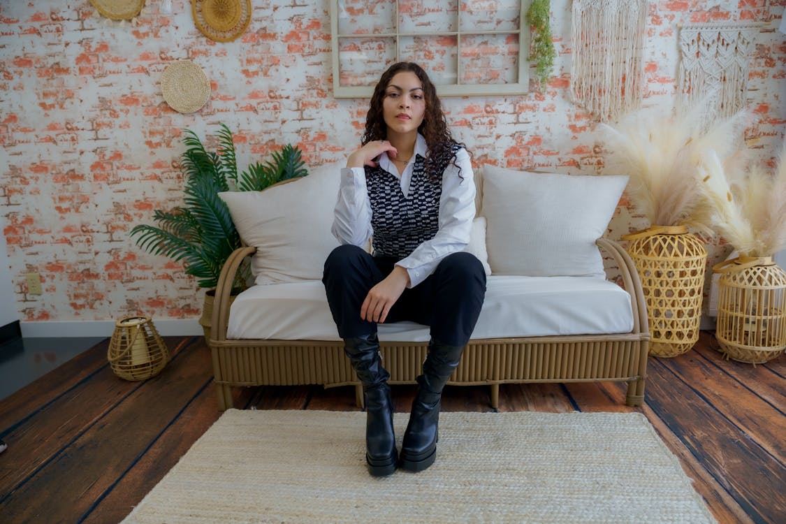 A woman sitting on a couch in front of a wall