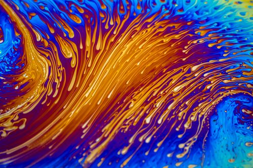 Free Vibrant abstract art depicting fluid swirls of blue and orange creating a dynamic visual effect. Stock Photo