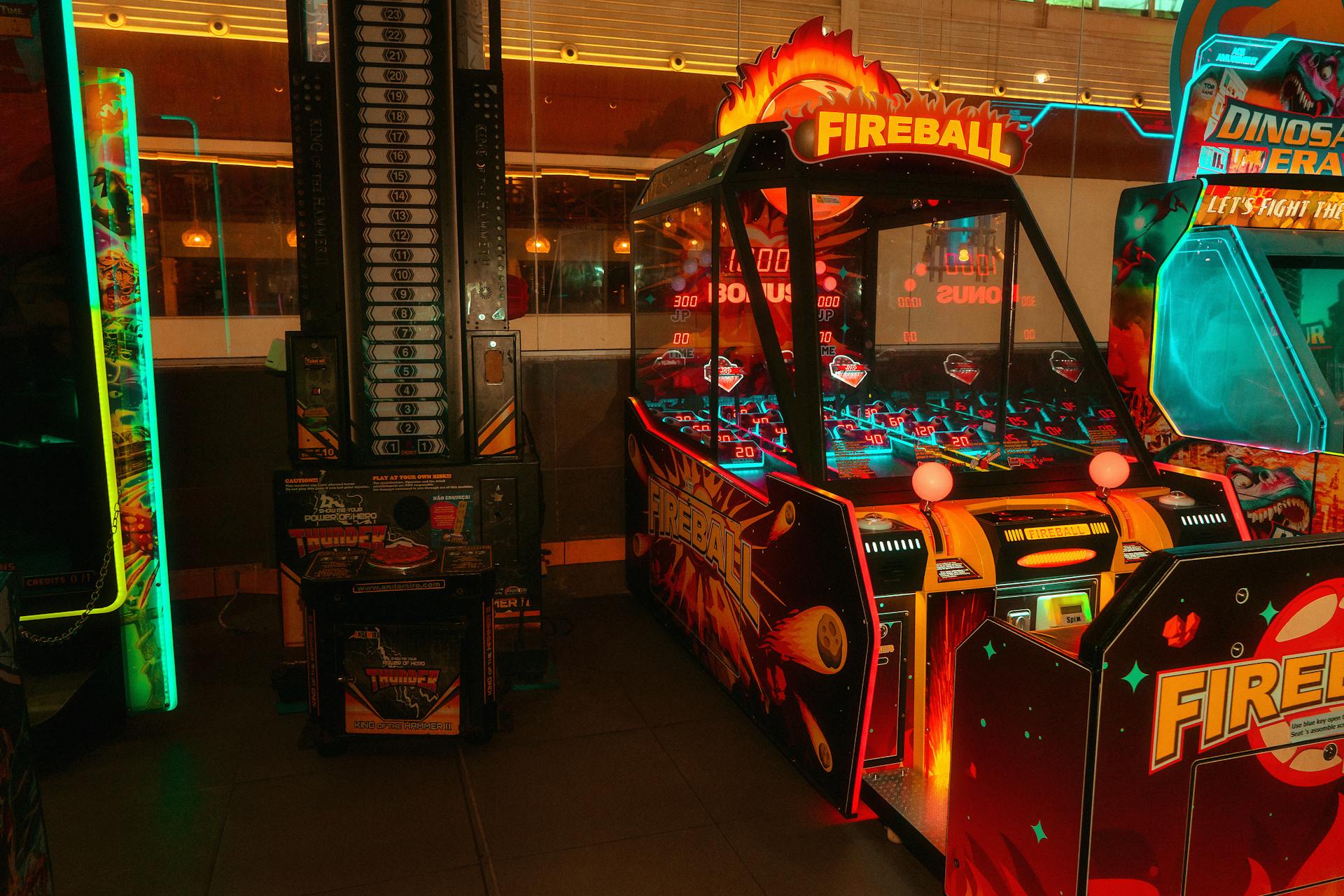 Colorful neon-lit arcade room featuring classic and modern game machines for fun and entertainment.