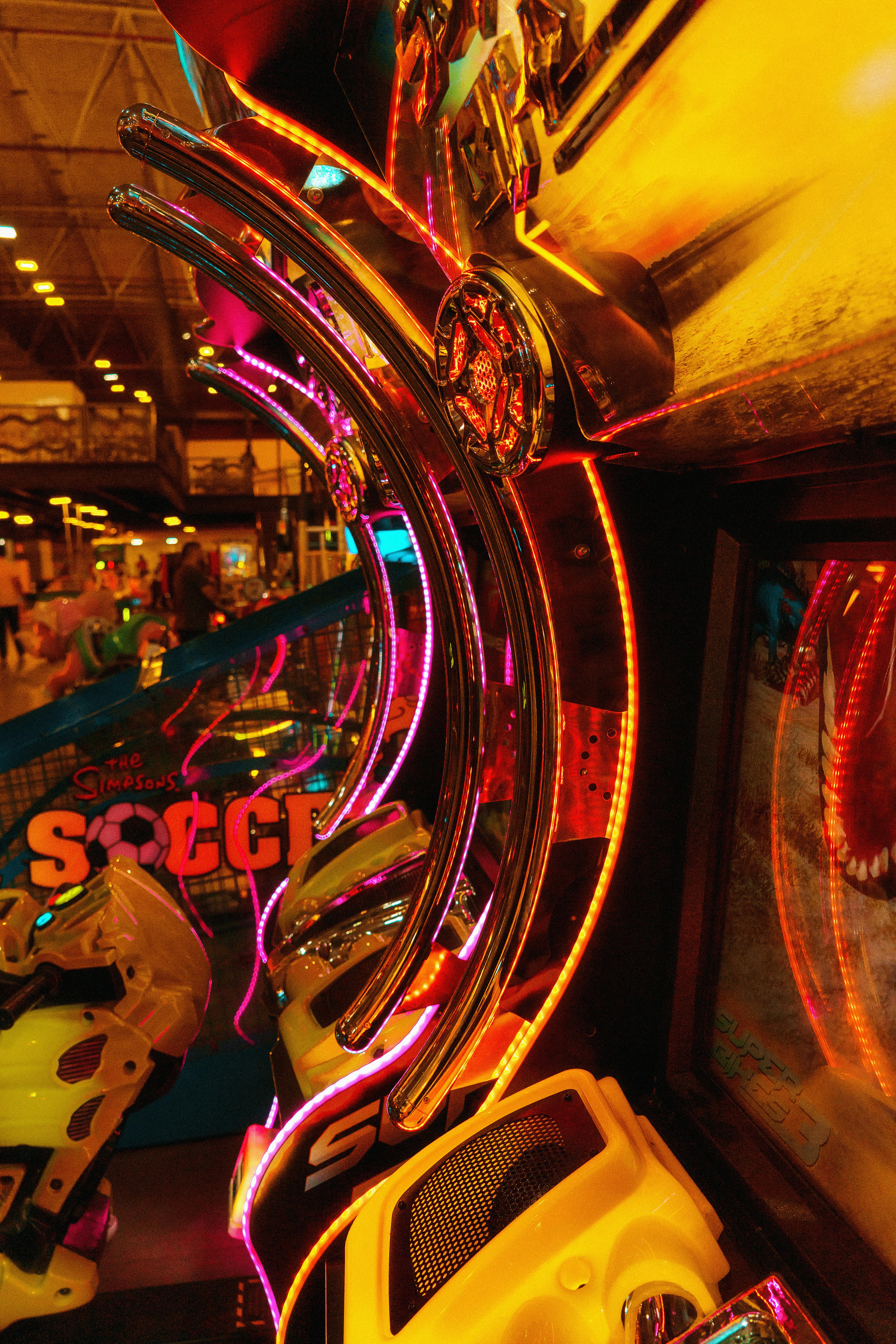 Close-up of a neon-lit arcade game machine showcasing a colorful and vibrant atmosphere.