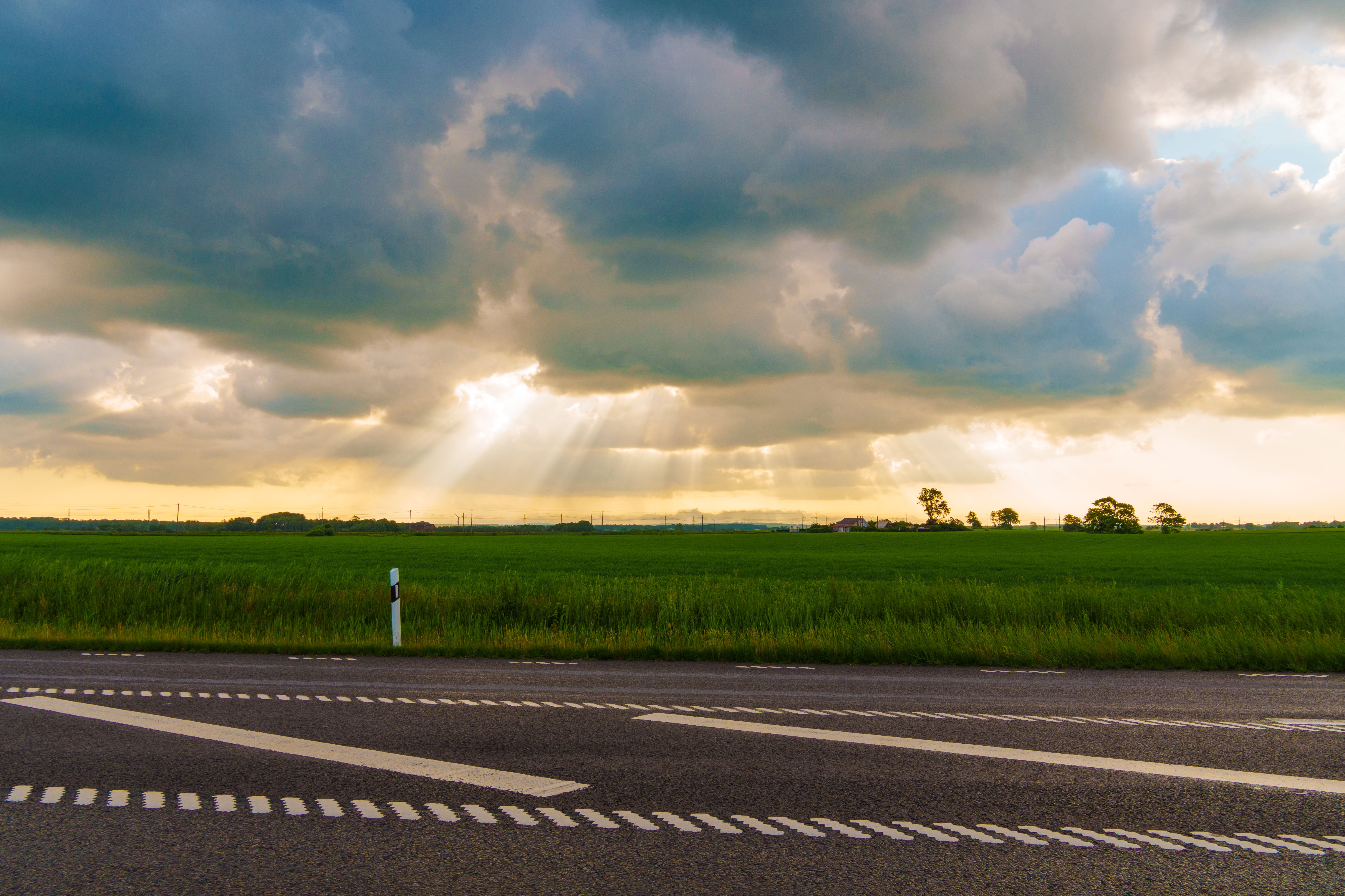 View of an Asphalt Road and Grass Field at Sunset · Free Stock Photo