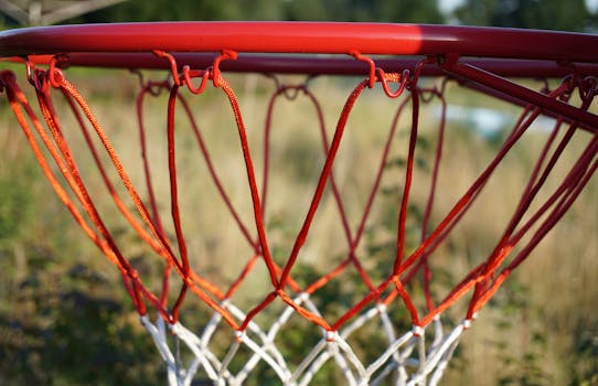 Detailed close-up of an outdoor basketball hoop and net, perfect for sports themes.