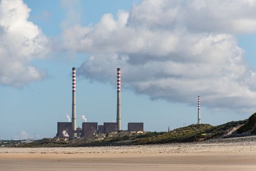 Free Cloudy day at a beach in Portugal featuring factory smokestacks. Stock Photo