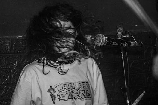 Energetic concert moment captured in black and white, highlighting music passion.