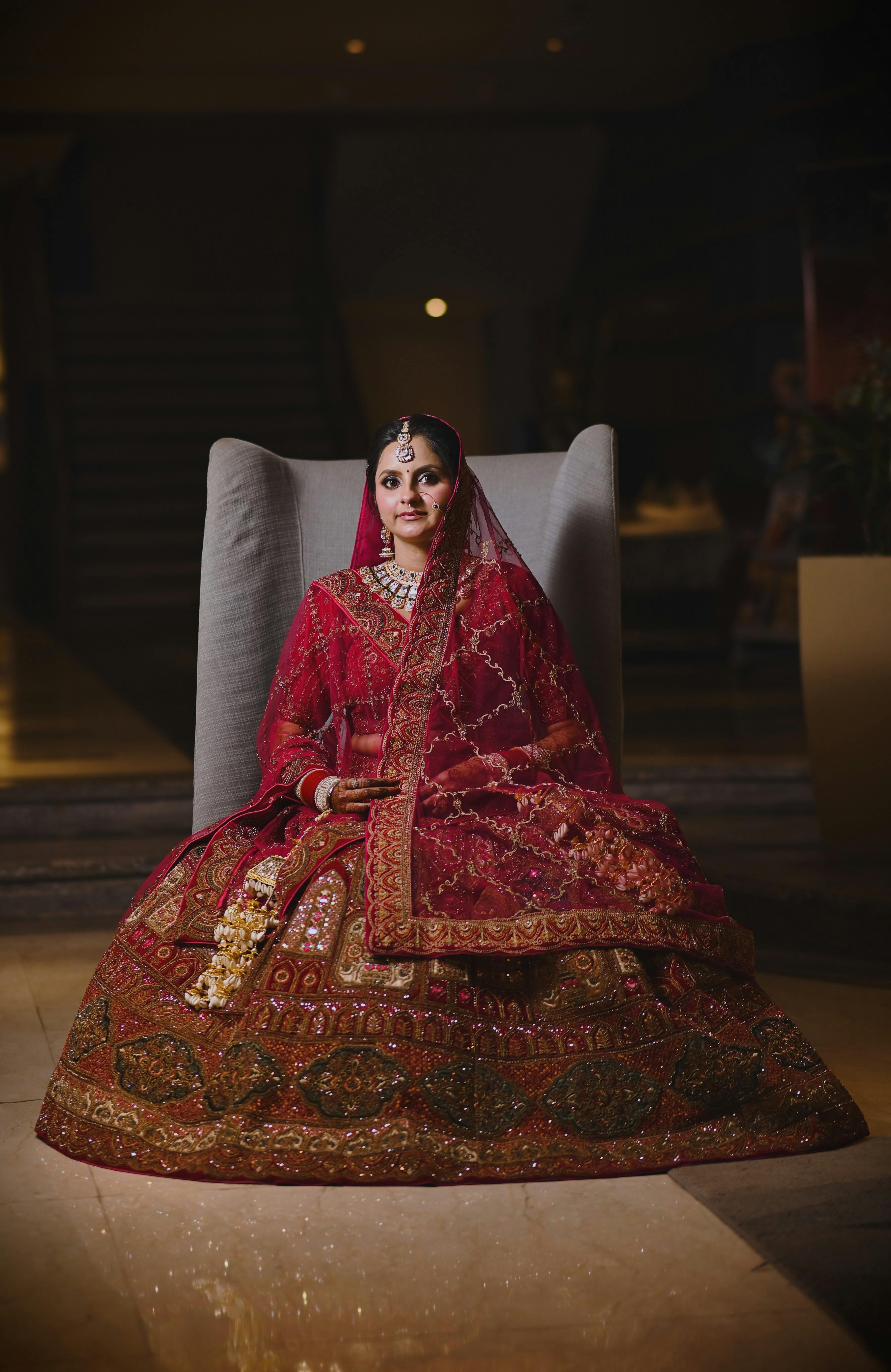Portrait of an Indian bride in a vibrant red lehenga, showcasing rich cultural heritage.