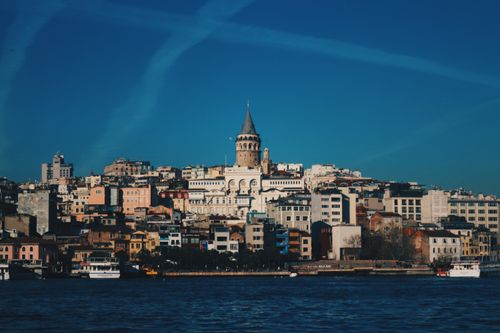 Free View of Galata Tower rising above the colorful cityscape of Istanbul, near the sea. Stock Photo