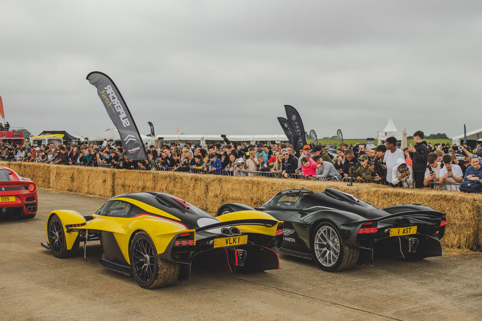Action-packed motorsport event featuring luxury supercars and enthusiastic spectators.