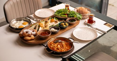 Free A vibrant Turkish breakfast spread featuring fresh ingredients and traditional tea, perfect for a delightful morning. Stock Photo