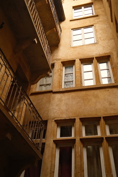 Free A courtyard with balconies and windows in an old building Stock Photo