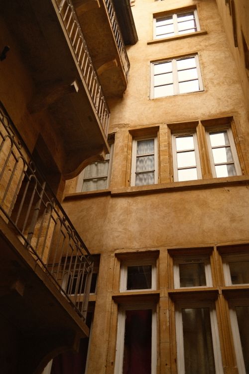 Free Explore this vintage urban building courtyard with multiple windows and balconies. Stock Photo