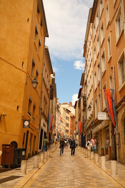 Free A narrow street with people walking down it Stock Photo