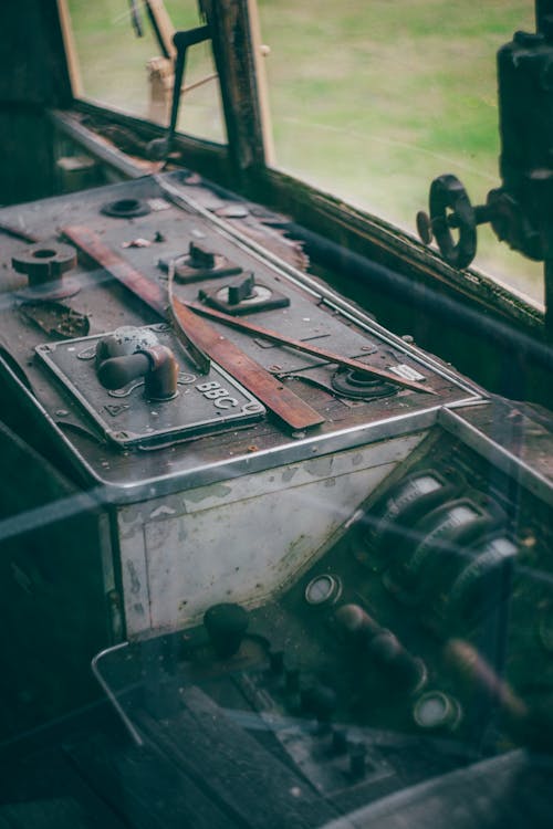 The inside of an old train car with a view of the dashboard