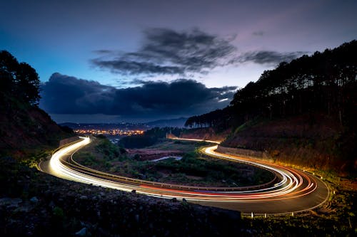 Free Time Lapse Photography of Vehicles Passing by Curved Road Stock Photo