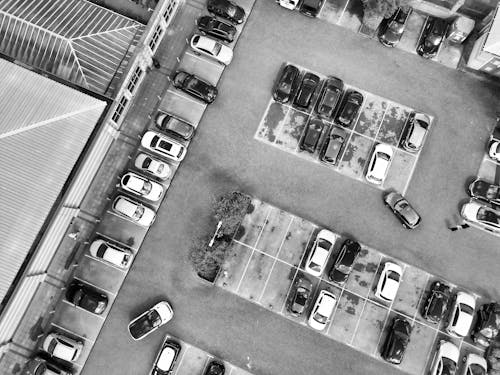 An aerial view of a parking lot with cars
