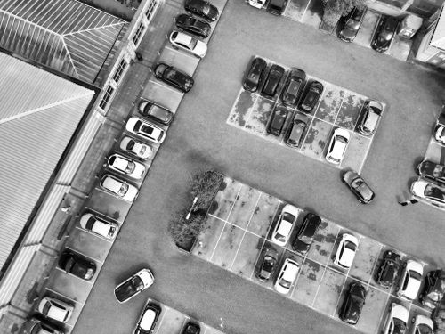 Free Aerial photograph of a parking lot in England, showcasing parked vehicles in an urban setting. Stock Photo