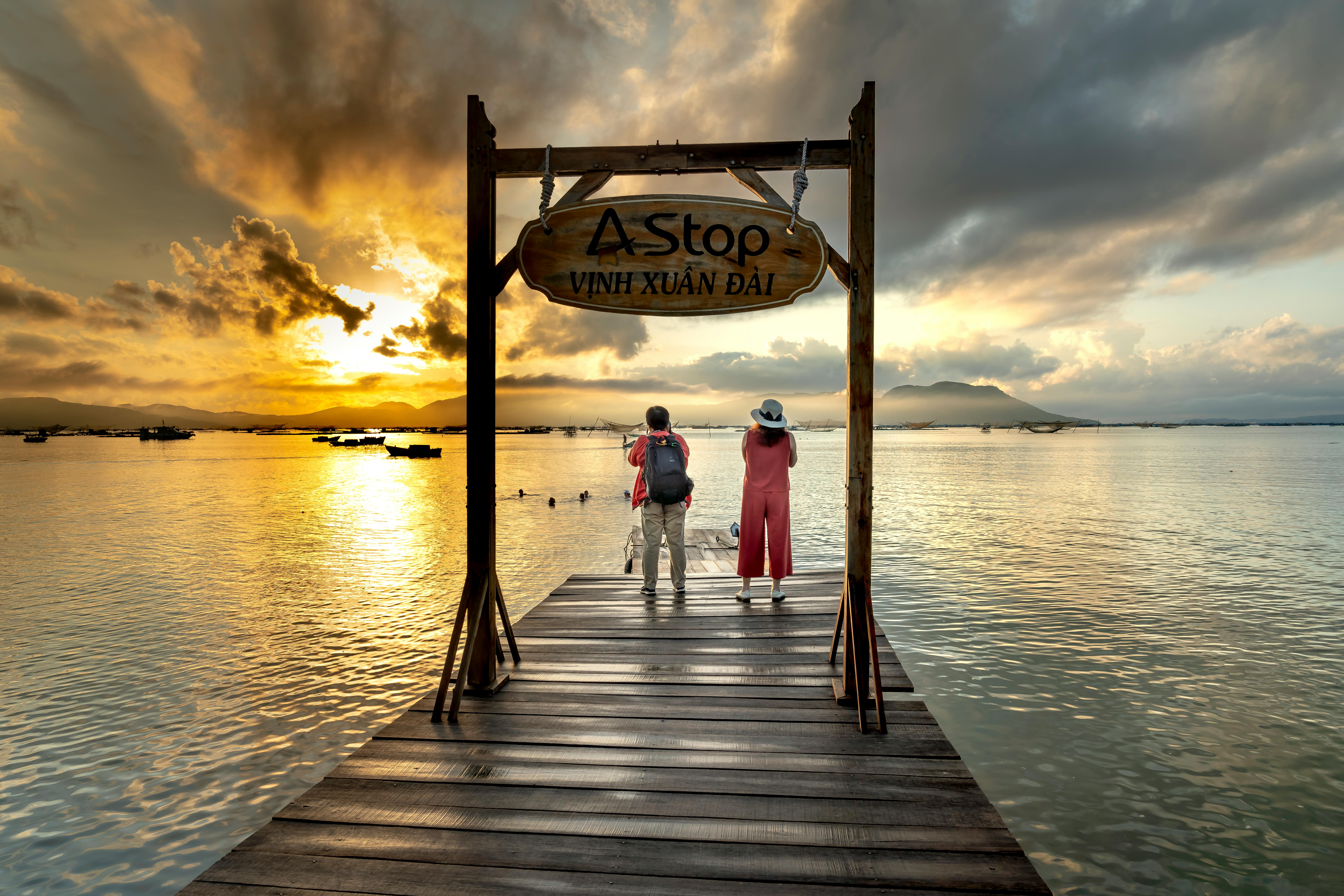 two woman standing on pier