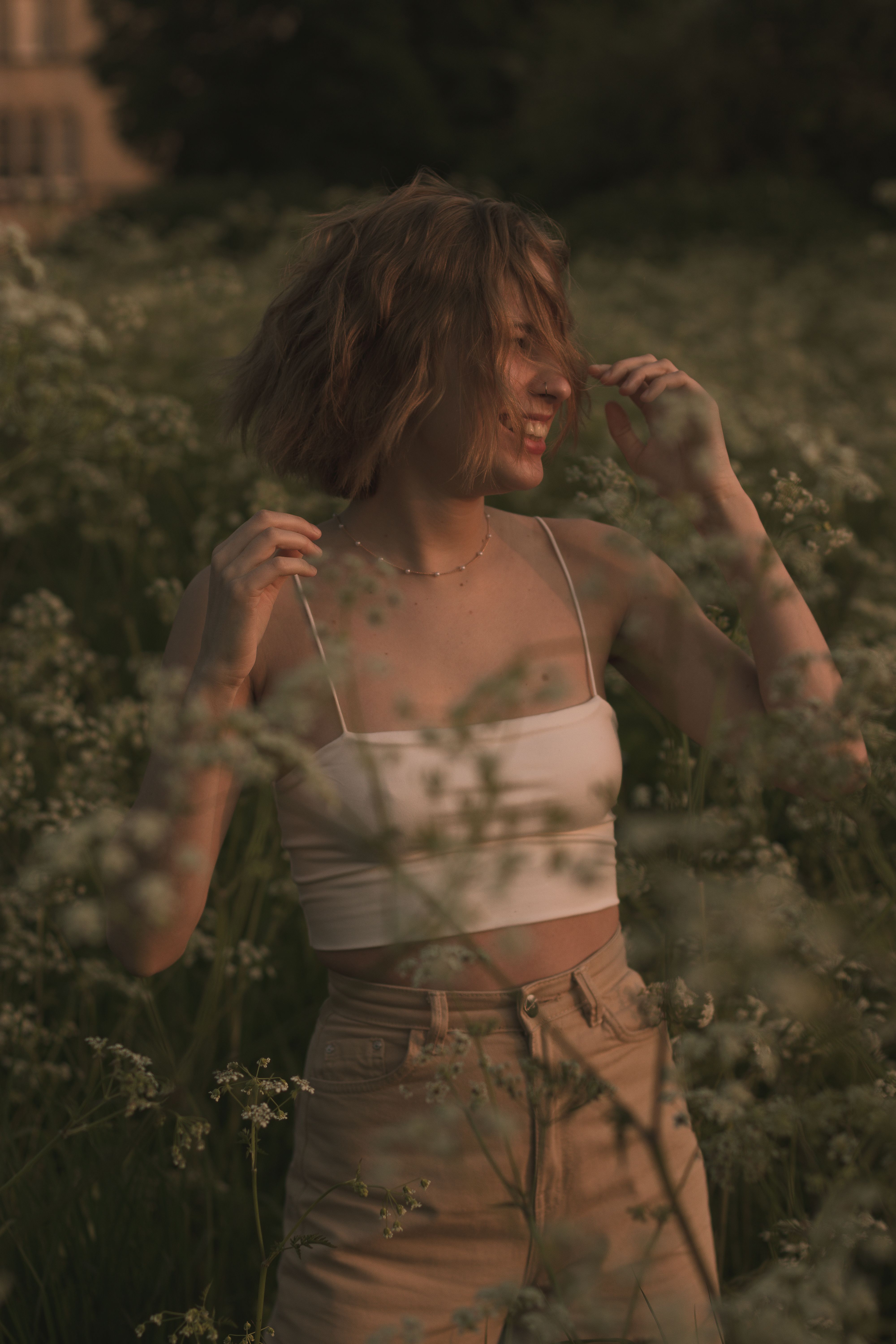 A woman enjoying a summer evening in a flower field in Bristol, UK.