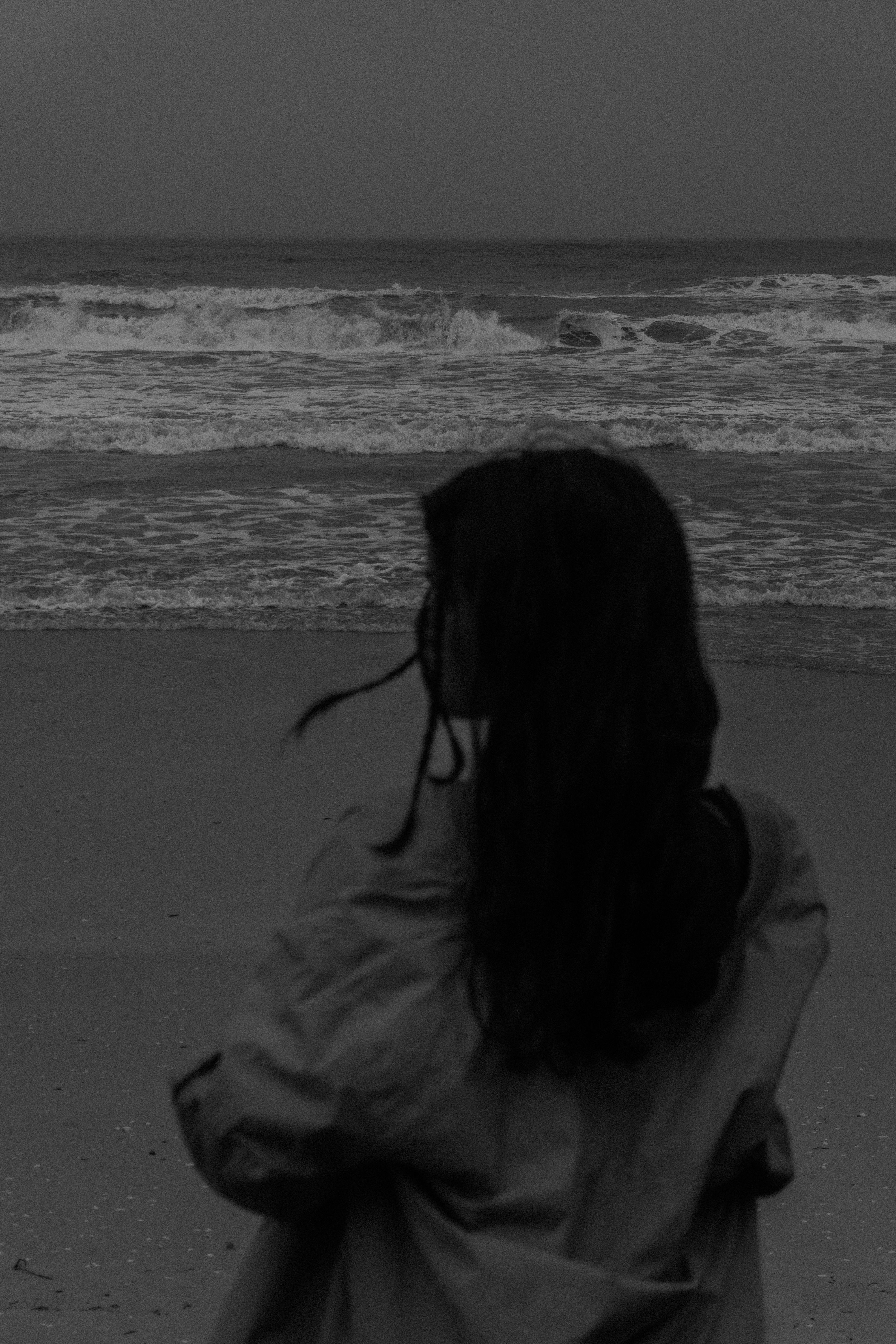 Woman Standing on Beach in Black and White · Free Stock Photo