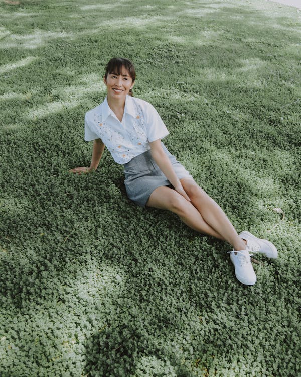 High-Angle Photo of Woman Sitting on Grass