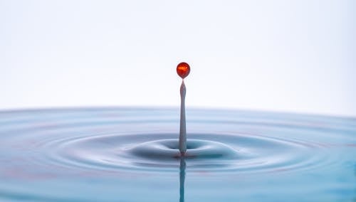 Red and White Water Splash in Water Surface