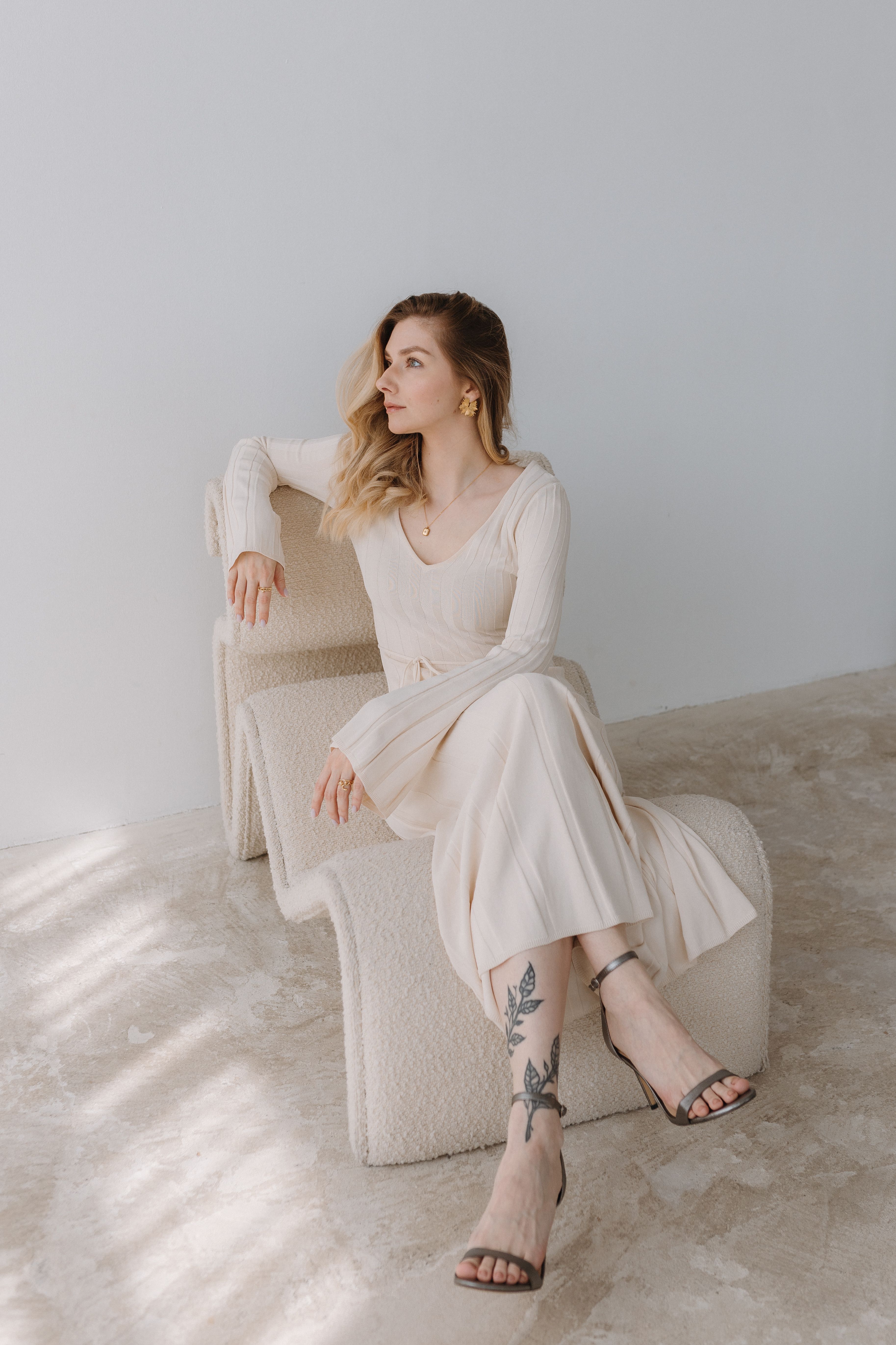 Woman in a cream bouclé shift dress