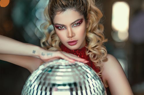 Alluring Woman Holding Disco Ball