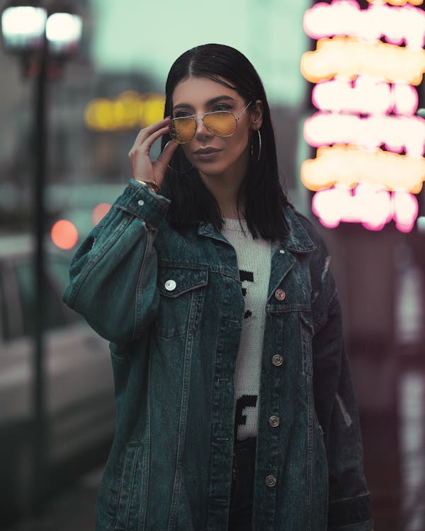 Selective Focus Photo of Woman in Denim Jacket and Sunglasses Posing