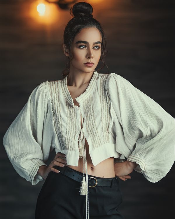 Woman in embellished blouse with dark jeans