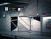 Sleek and modern subway station interior with empty platform and reflective surfaces.
