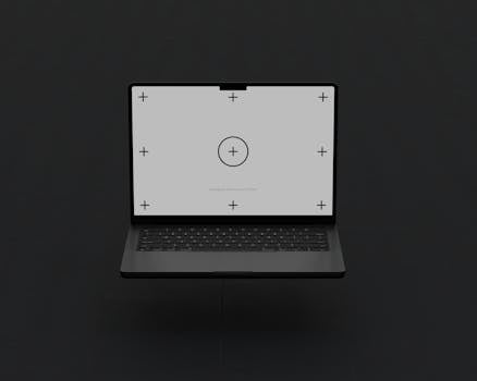 Floating laptop with calibration marks on black background, studio shot.