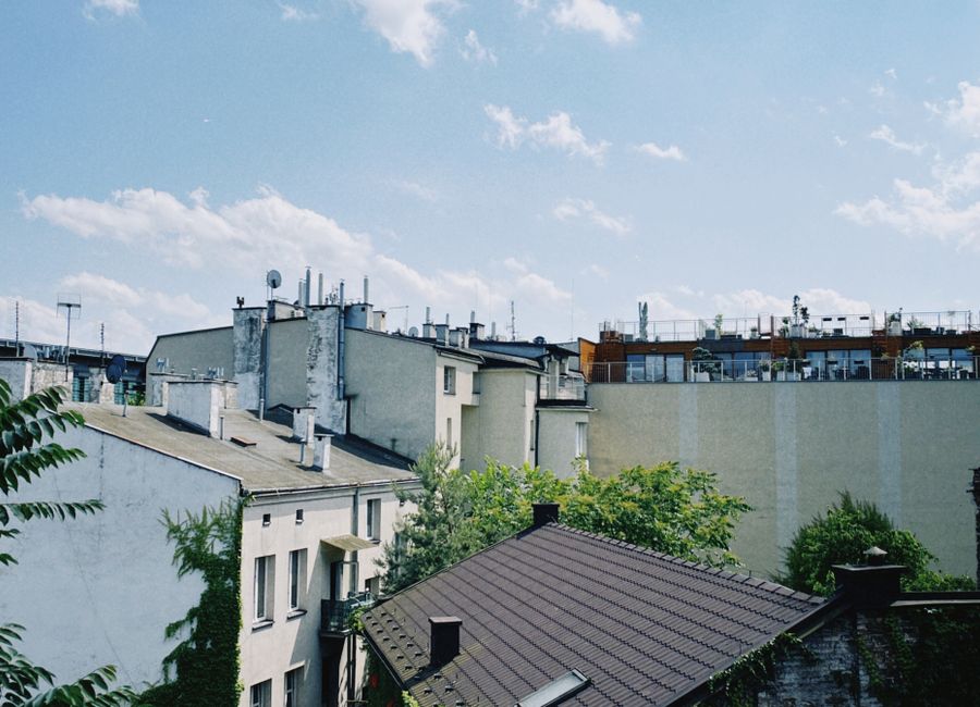 A picturesque view of Kraków's residential rooftops on a bright and sunny day.