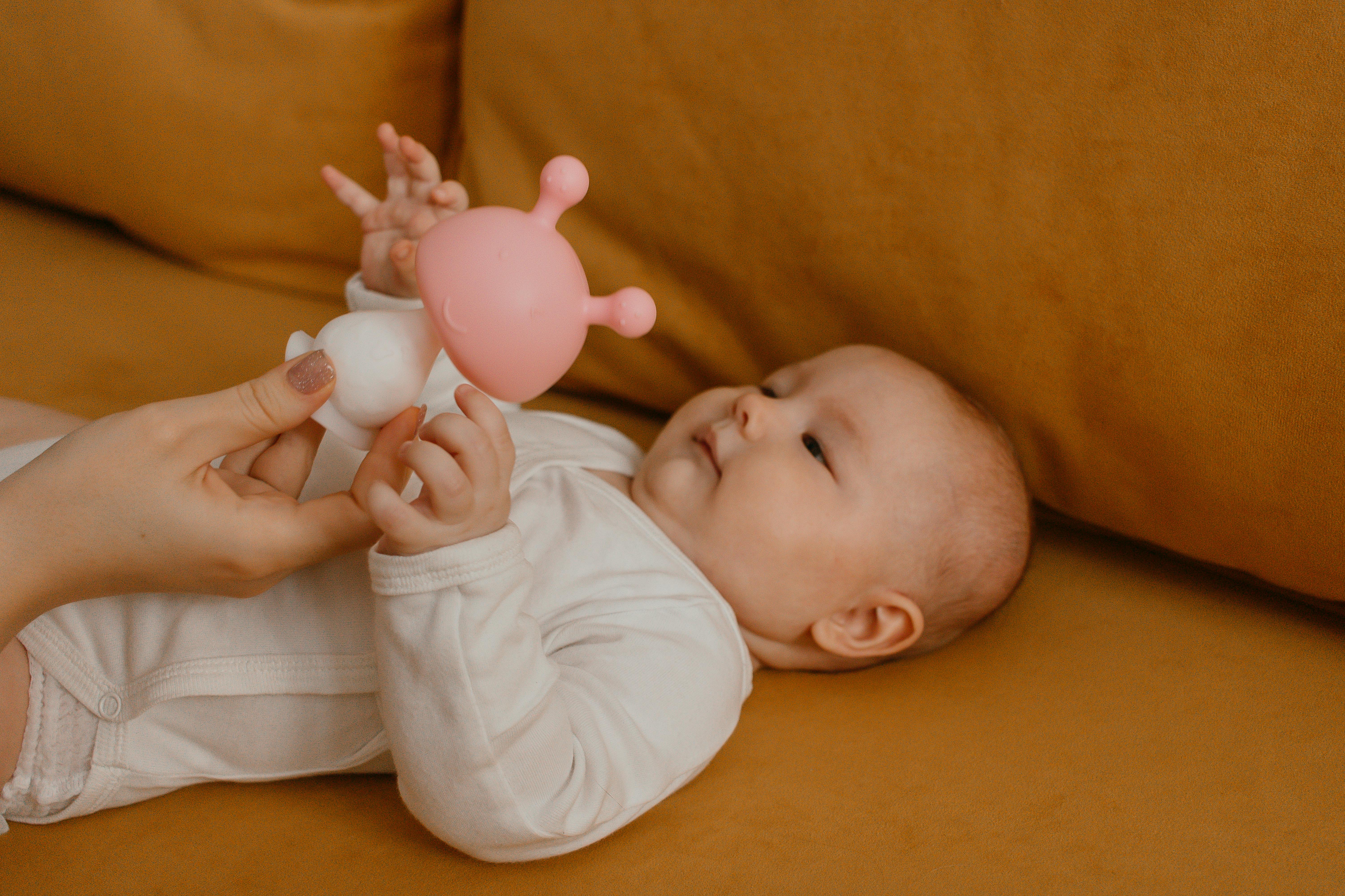 A parent gently redirects a toddler's hand from an electrical outlet to a soft toy, demonstrating child-proofing and redirection - Parenting strategies for discipline