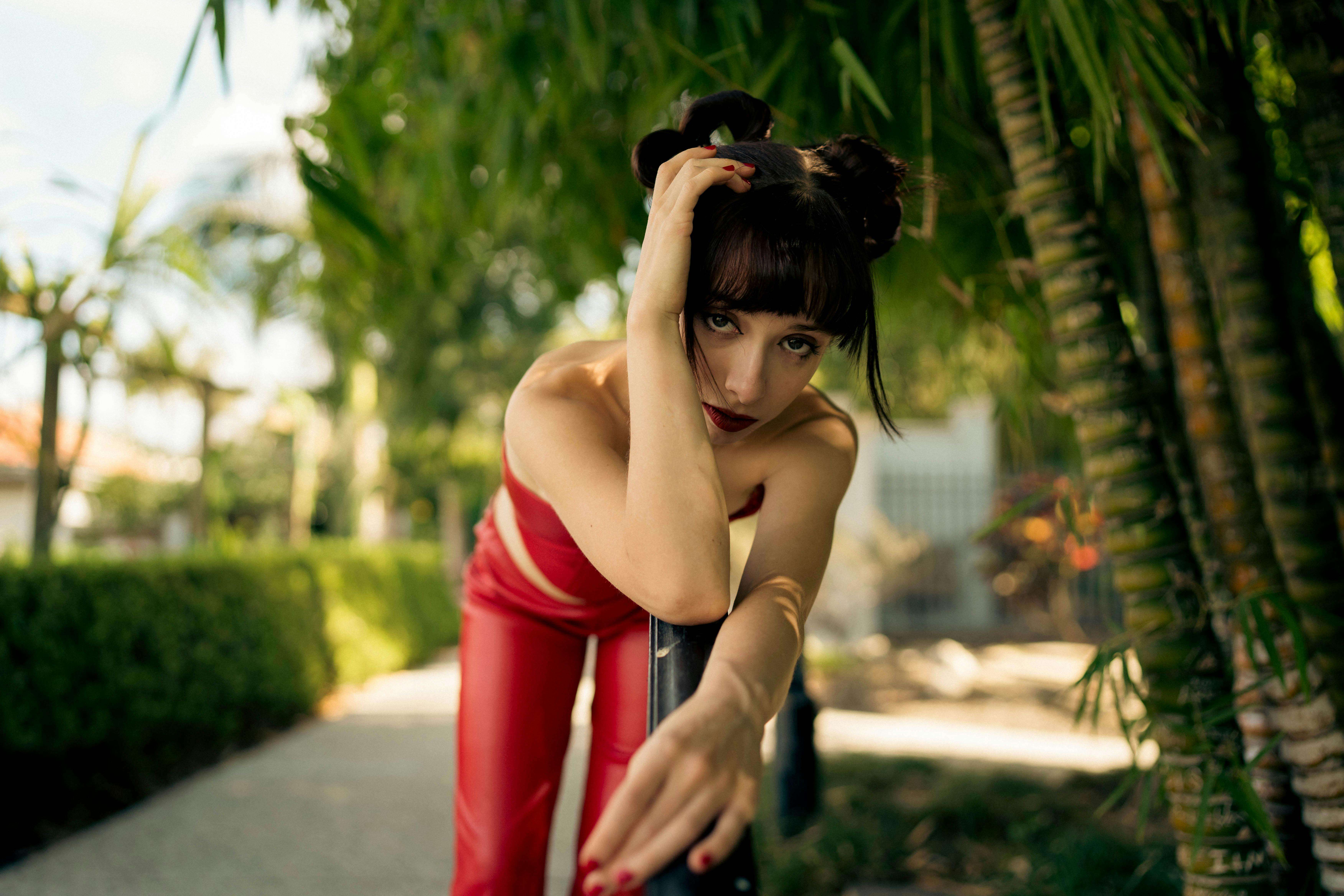 Stylish outdoor portrait of a woman in a red outfit with natural background.