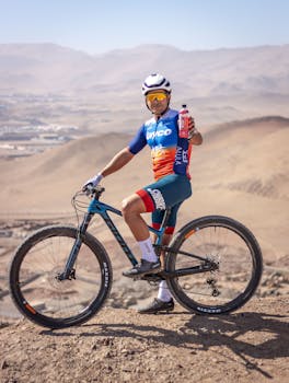 Cyclist holding a water bottle while mountain biking in Alto Hospicio, Chile.