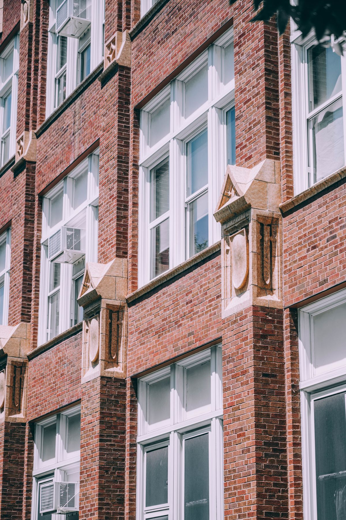 Historic red brick and limestone facade of a vintage Chicago residential building