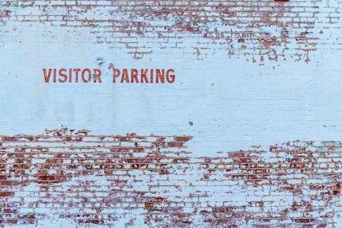 Free Visitor Parking Text Painted on Stonewall Stock Photo