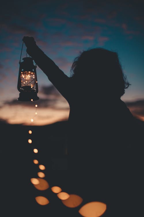 Free Silhouette Photo Of Person Holding A Lantern Stock Photo