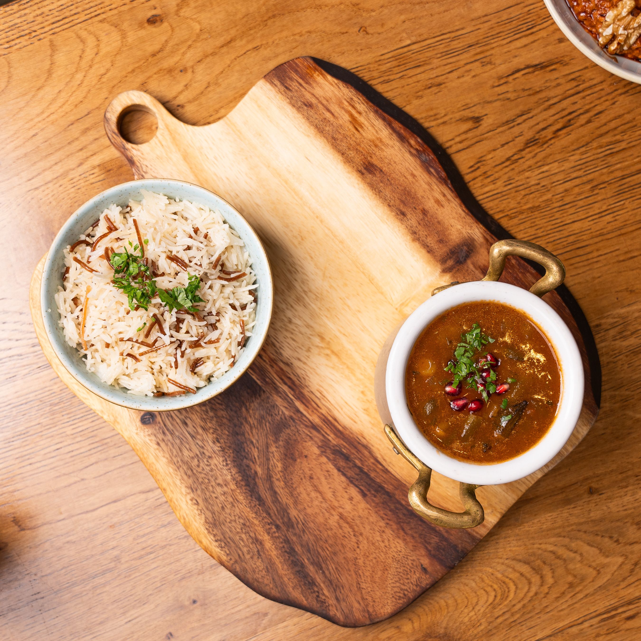 Top view of rice and curry on a wooden board, perfect for a hearty meal.