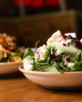 Delicious close-up of a spinach salad with pomegranate and cheese, perfect for healthy meals.