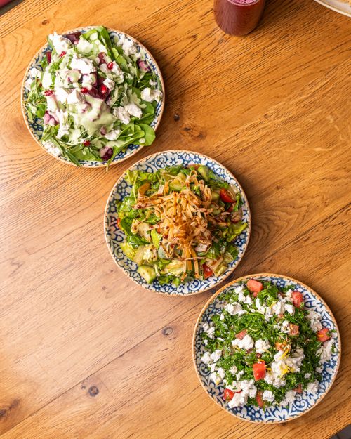 Free Colorful salads with fresh ingredients served on decorative plates from above. Stock Photo